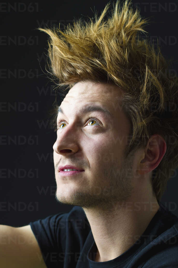 Close Up Of Young Man With Spiky Hair Against Black Background Looking Up Mbef000115 Martin Benik