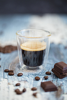 Glass Cup Of Espresso Roasted Coffee Beans And Dark Chocolate On Wood Stockphoto