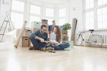 Couple Surrounded By Cardboard Boxes Sitting On Floor Rbf004724
