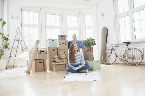 Couple Surrounded By Cardboard Boxes Sitting On Floor Rbf004724