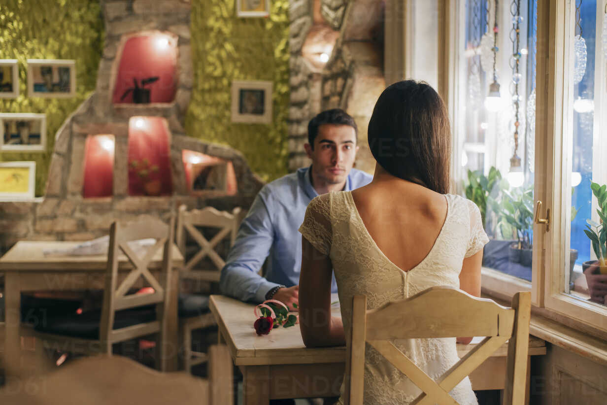 Back View Of Young Woman Sitting Face To Face With Her Boyfriend At