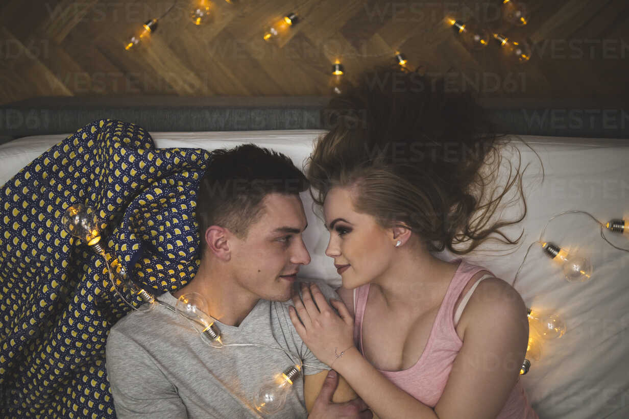 Romantic Young Couple Cuddling In Bed With Fairy Lights Awf00051 Inner Vision Pro Westend61