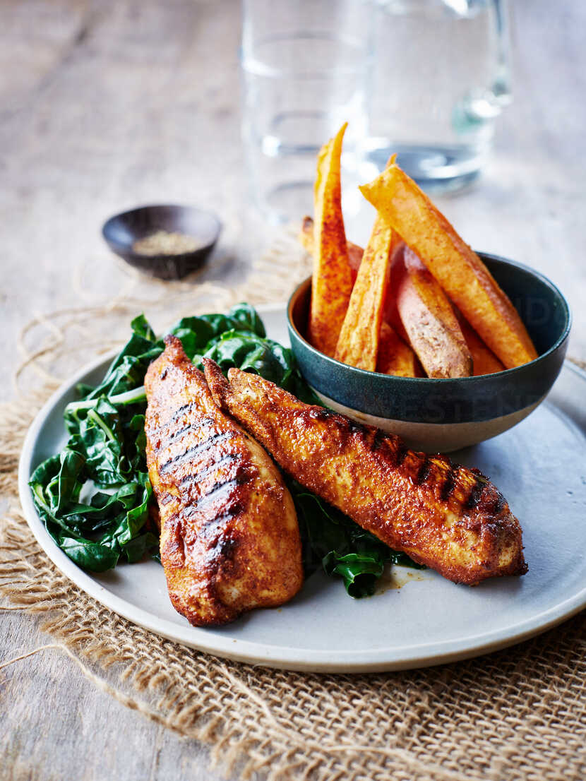 Cajun Chicken With Chard And Sweet Potato Chips Stockphoto