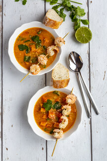 Two Bowls Of Sweet Potato Soup With Shrimps Coconut Flakes And Fresh Coriander Stockphoto