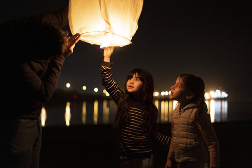 Excited Man With Floating Sky Lantern At Night Errf Eloisa Ramos Westend61