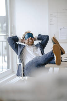 Businessman Having A Power Nap At Desk In Office Gusf03297 Gustafsson Westend61