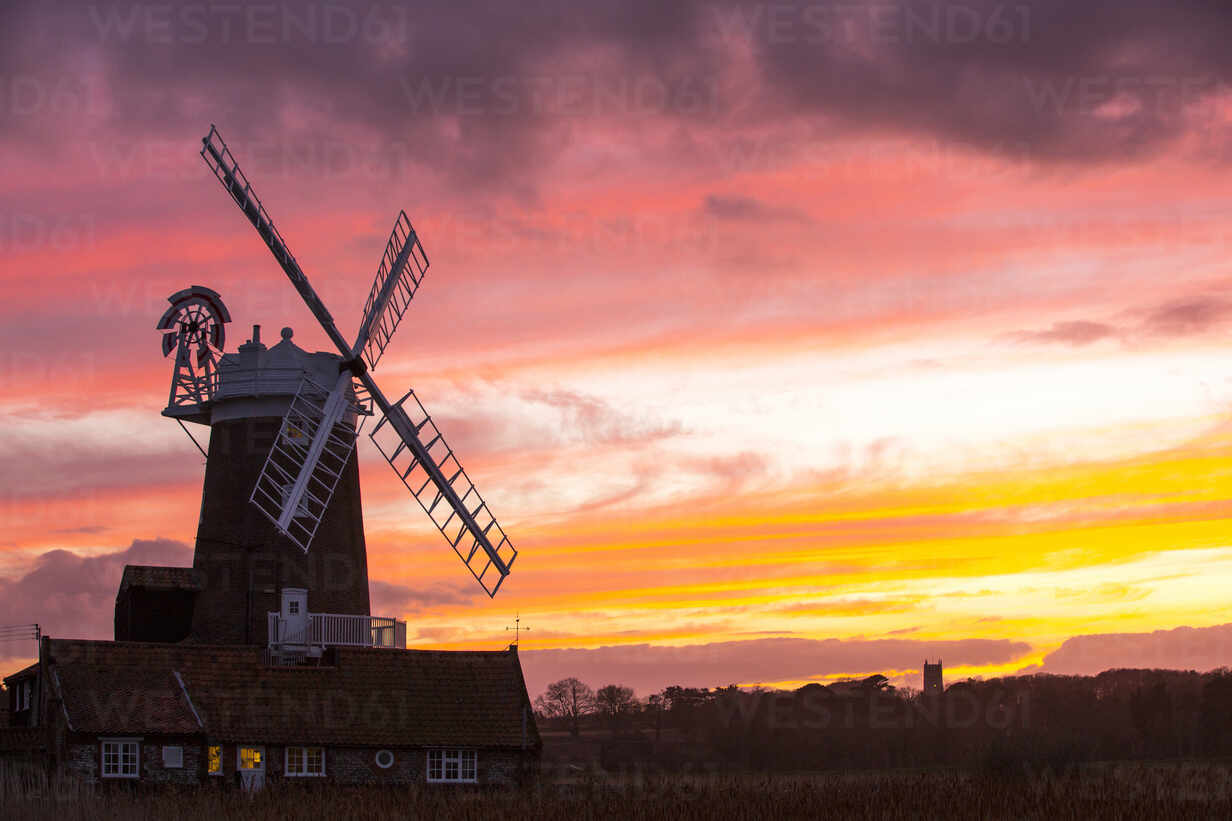 A Windmill At Cley Next The Sea North Norfolk Uk With Blakeney Church In The Background