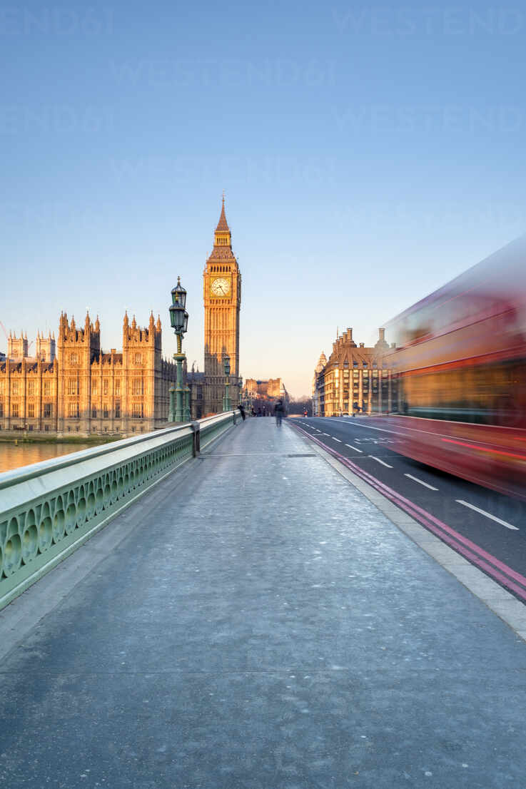 Double Decker Bus Passes On Westminster Bridge In Front Of Westminster Palace And Clock Tower Of
