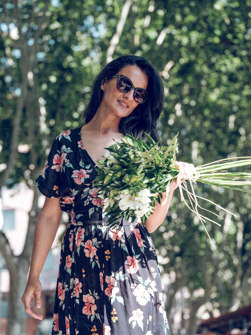 Download Attractive Woman With Bunch Of Flowers Stockphoto