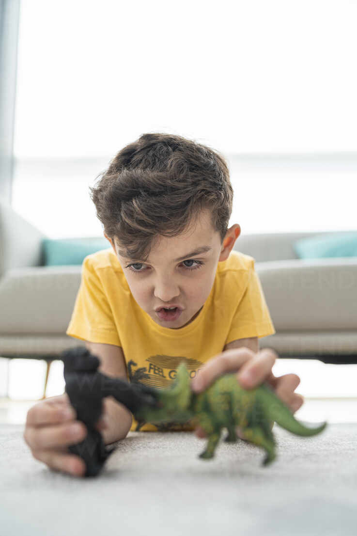 Close Up Of Cute Boy Playing With Toys On Carpet In Living Room Stockphoto