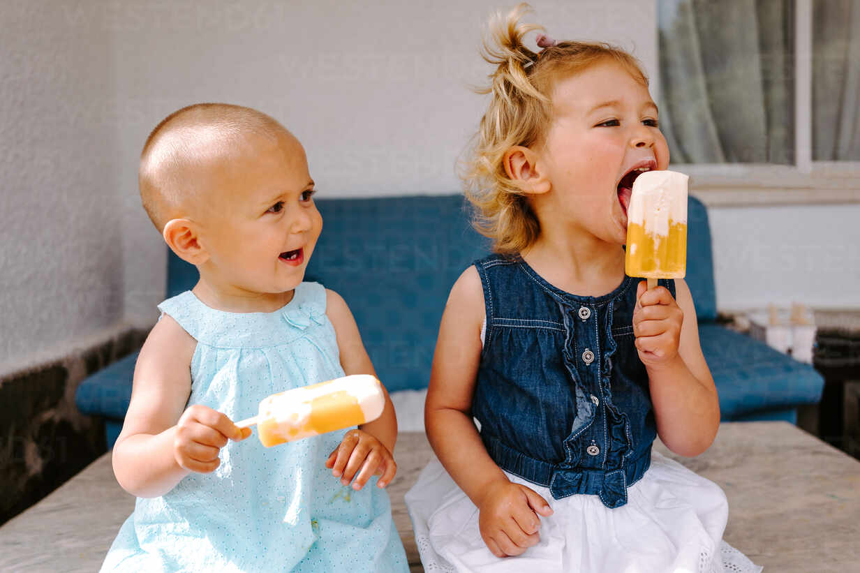 Cute Little Girls Eating Yummy Popsicles While Enjoying Summer And Sitting Together In Backyard Adsf Addictive