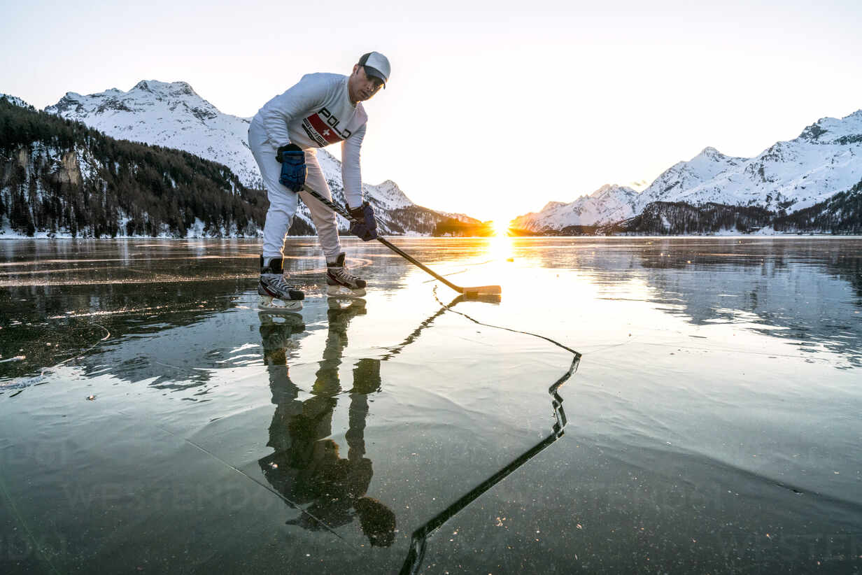 Front View Of Ice Hockey Player On Cracked Surface Of Frozen Lake Sils Engadine Graubunden Canton